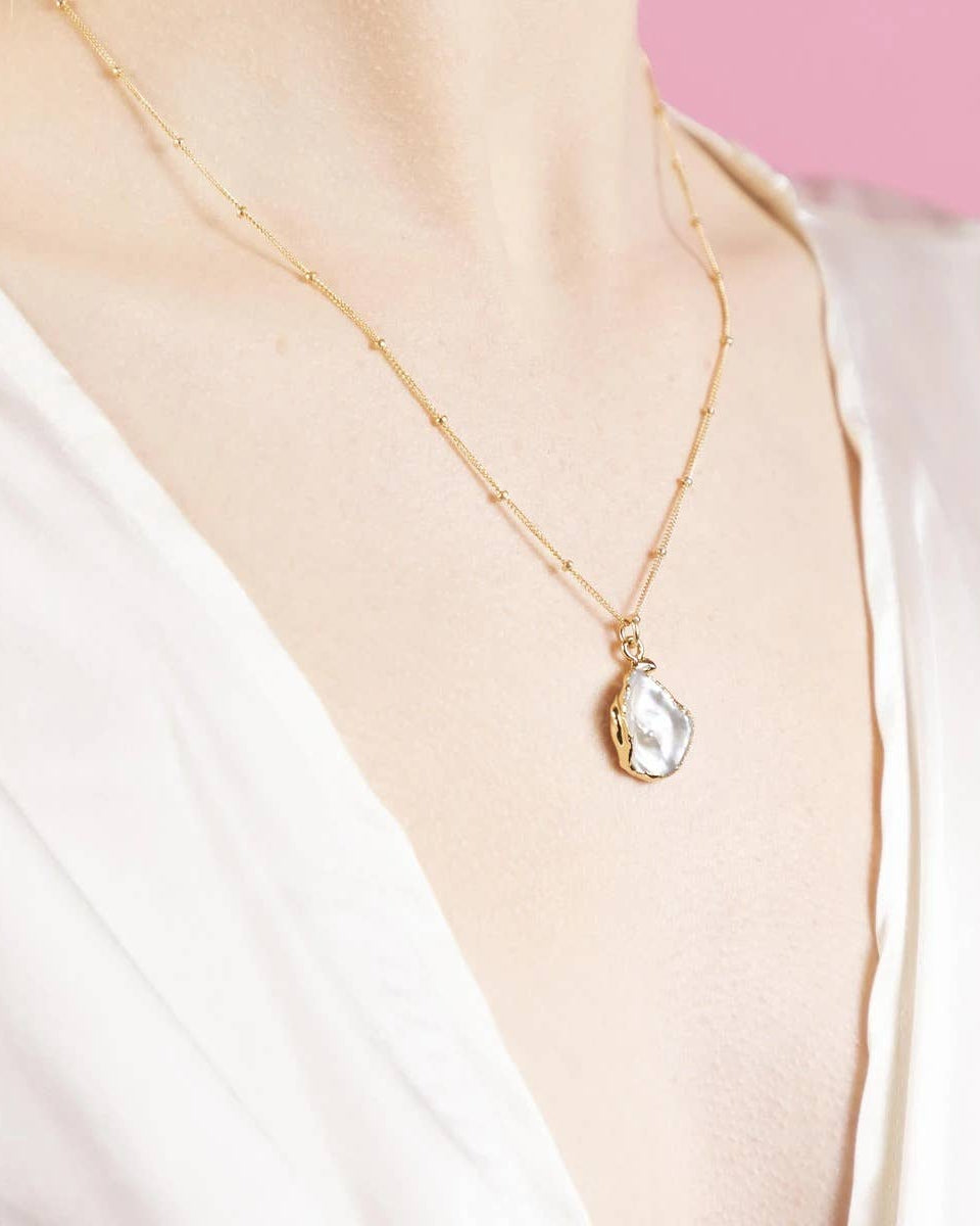 Gold satellite chain necklace with irregular baroque pearl pendant on model