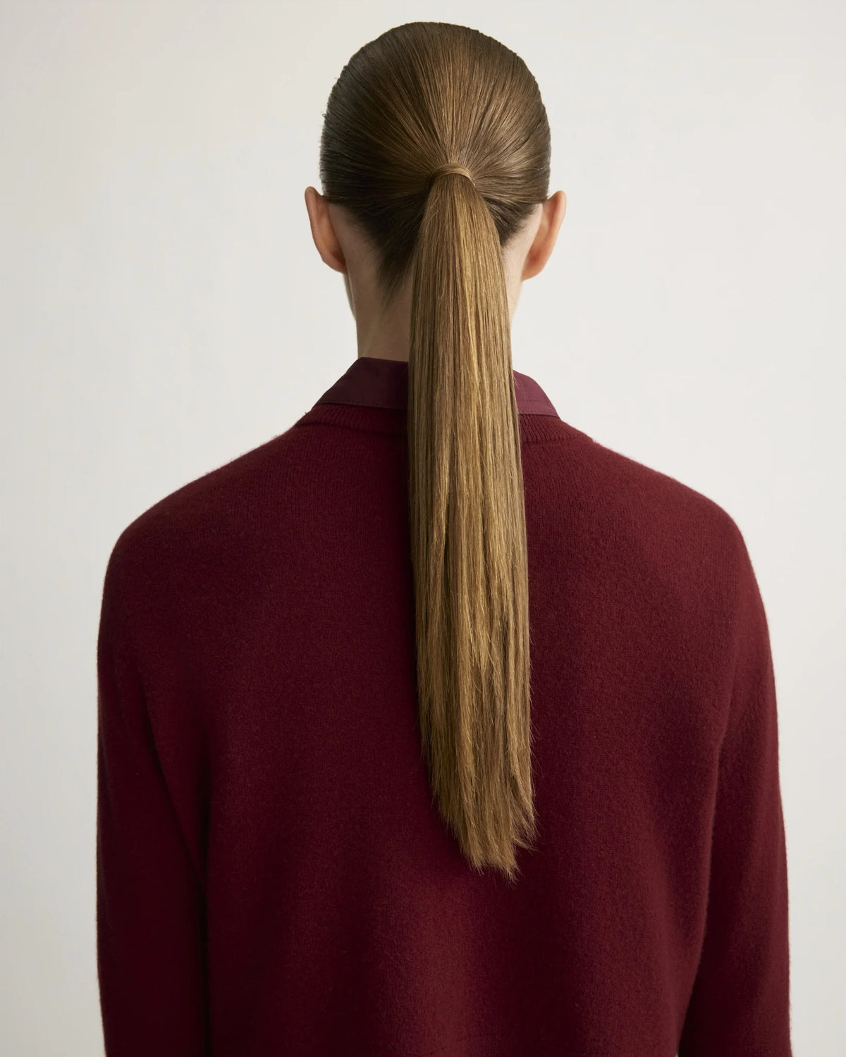 Warren Berry crewneck sweater, back view, model with long straight ponytail