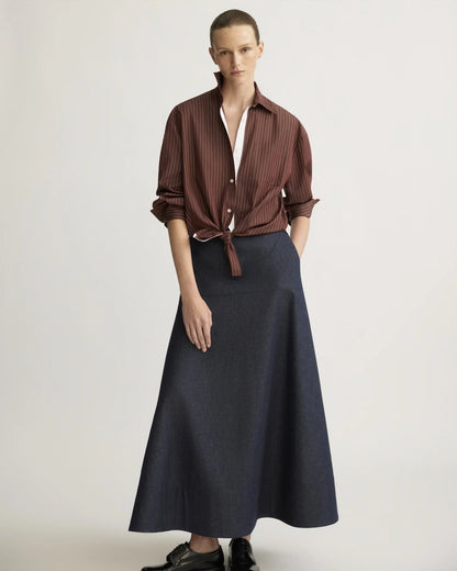 Oxblood striped oversized boyfriend shirt tied at waist, worn with navy maxi skirt