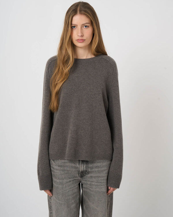 Women's taupe brown cashmere crewneck sweater with ribbed cuffs and hem paired with grey jeans