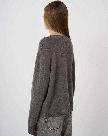 Women's oversized gray cashmere sweater, back view, ribbed hem, paired with gray jeans
