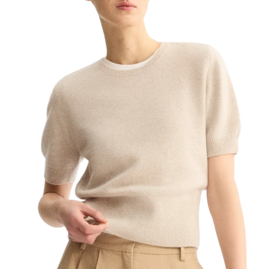 Model wearing beige short sleeve crew neck sweater with neutral pants