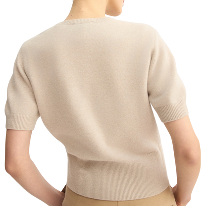 Back view of model wearing beige short sleeve crew neck sweater