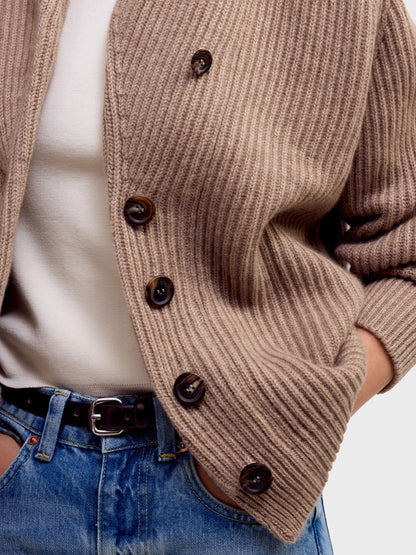 Close-up detail of brown undyed ribbed knit cardigan with dark horn buttons and wide cuffs