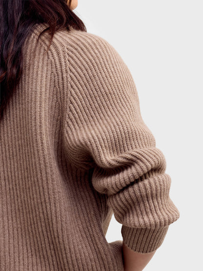 Close-up back detail of ribbed brown undyed cardigan sleeve and body texture