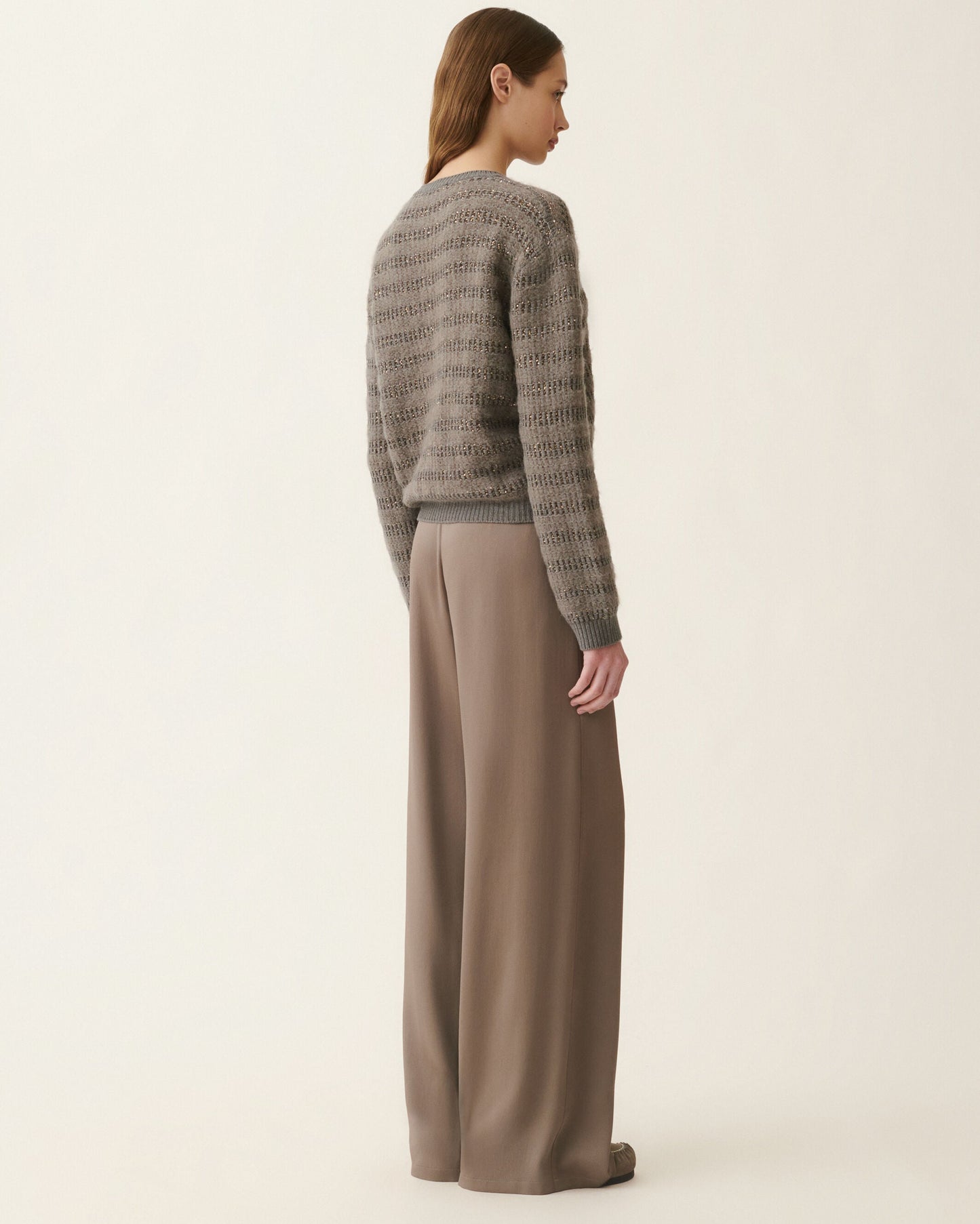 Gray mohair sweater with sequin stripes and wide-leg taupe trousers, back view