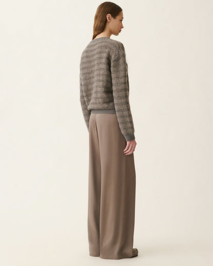 Gray mohair sweater with sequin stripes and wide-leg taupe trousers, back view