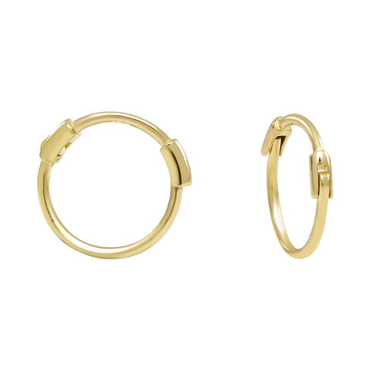 Two small gold thin huggie hoop earrings displayed on white background