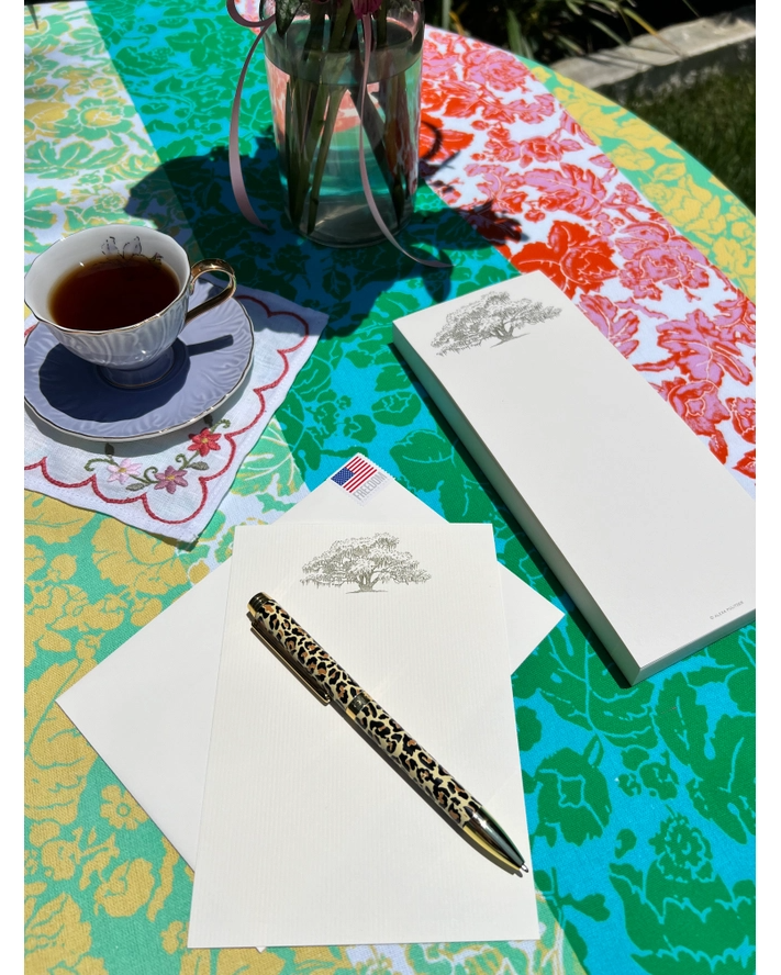 Oak tree long notepad with leopard pen, tea cup, and envelopes on colorful table