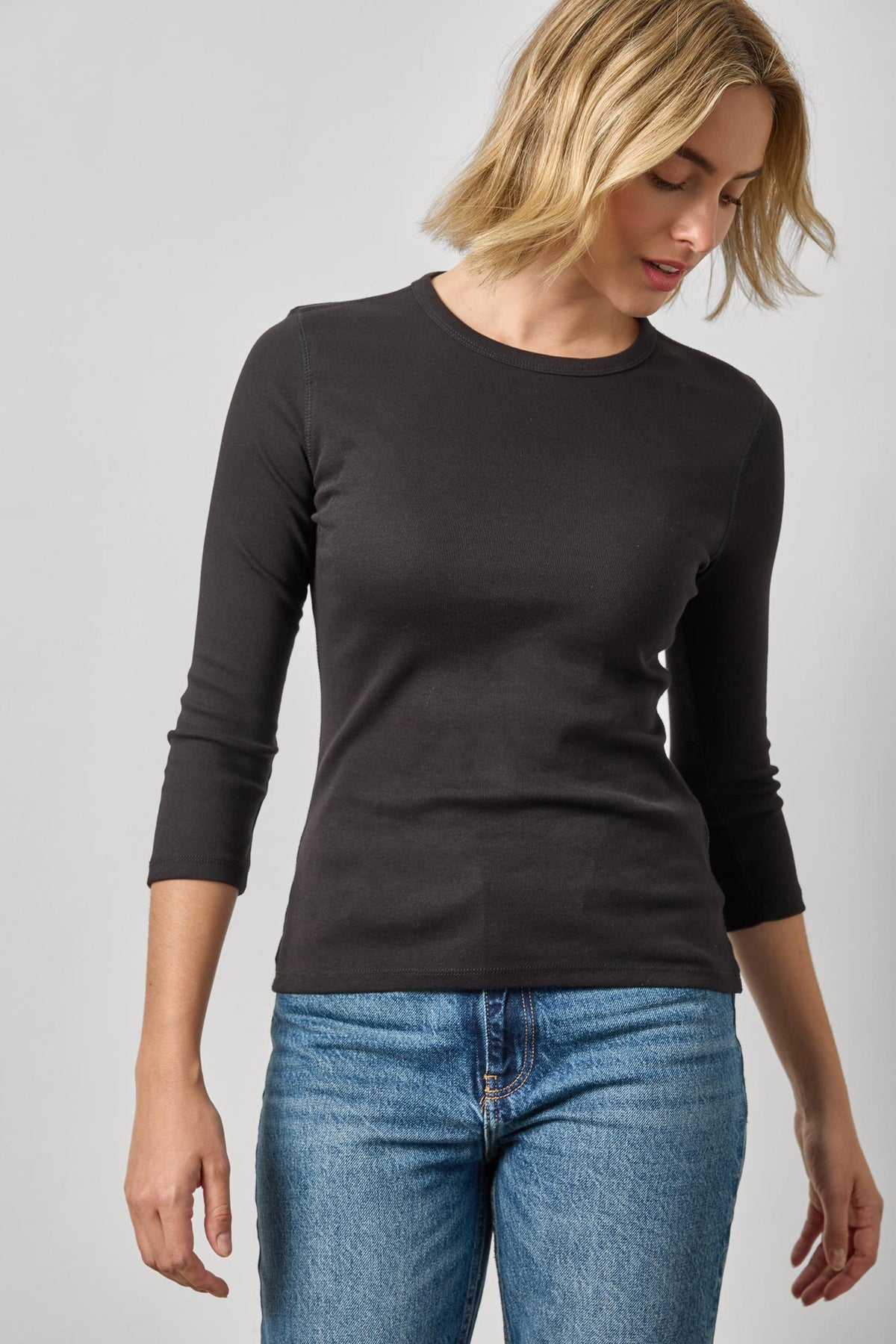 Model wearing Lilla P black 3/4 sleeve fitted crew neck top with jeans