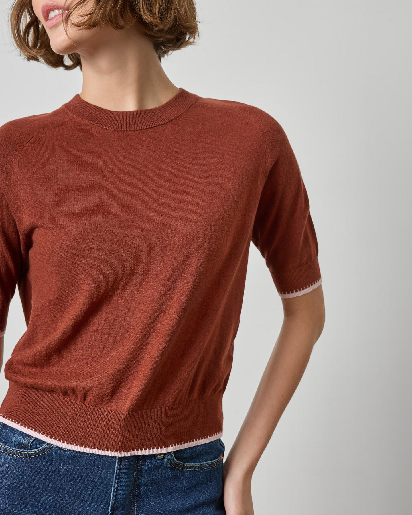 Rust brown short sleeve crewneck sweater with contrast pink trim details
