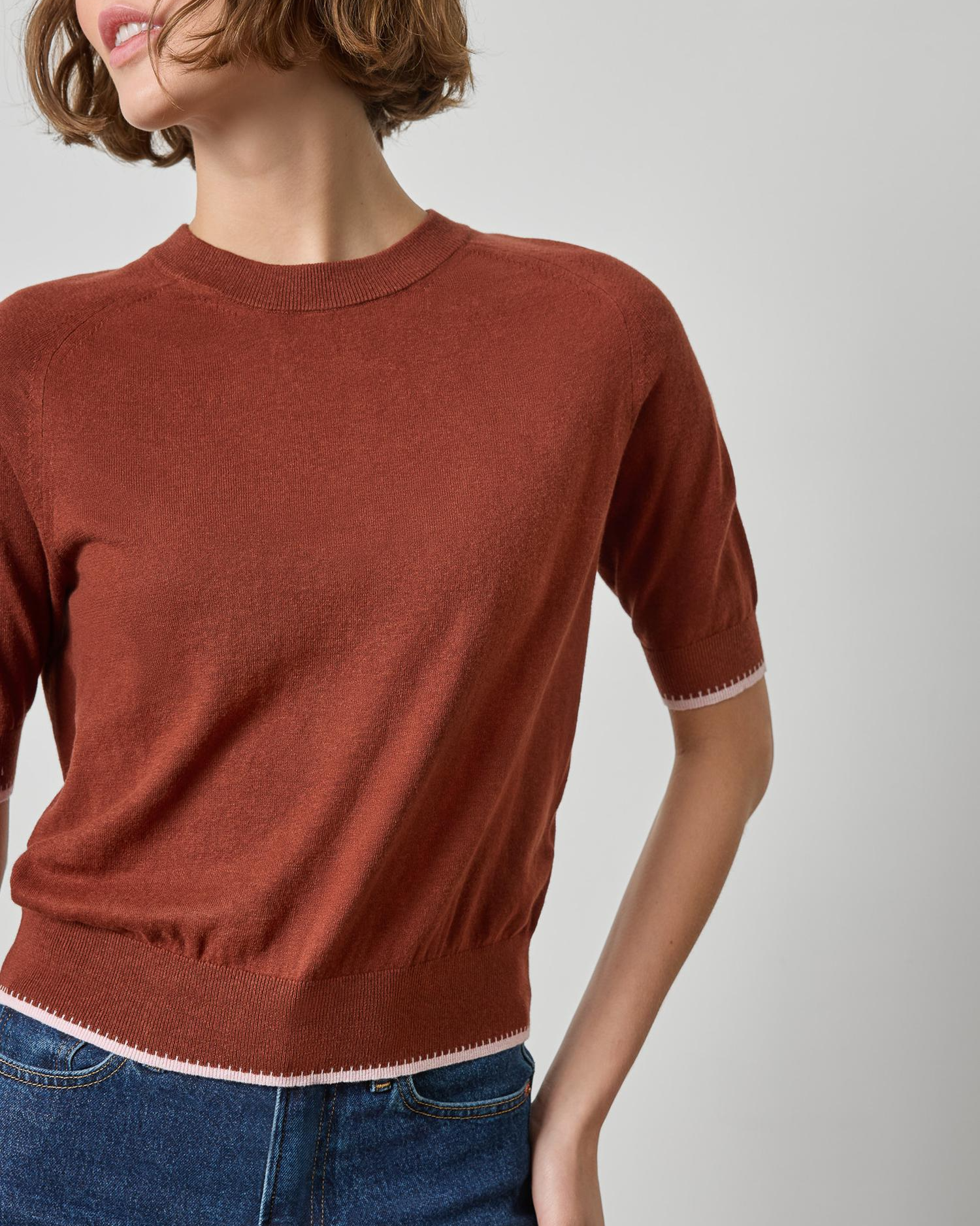 Rust brown short sleeve crewneck sweater with contrast pink trim details