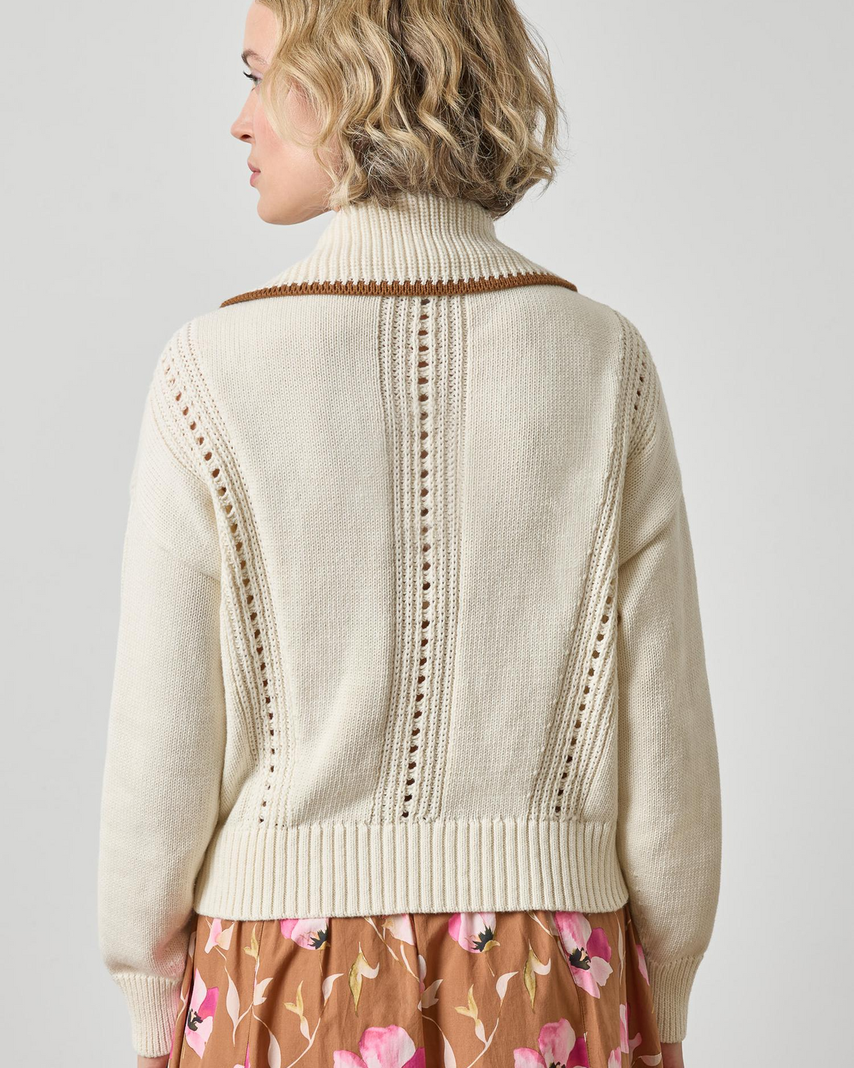 Cream knit zip cardigan with open-stitch panels and brown contrast collar trim