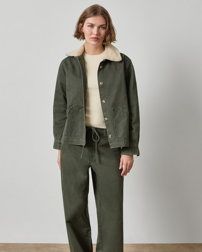 Olive green washed twill jacket with sherpa collar and gold buttons on woman