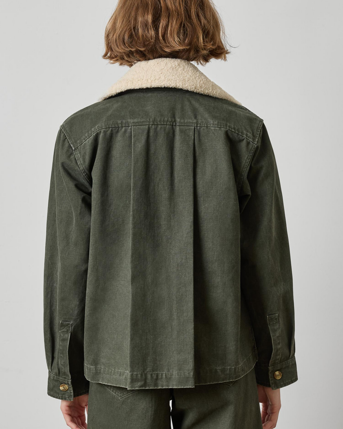 Washed olive green twill jacket with sherpa collar and pleated back, back view