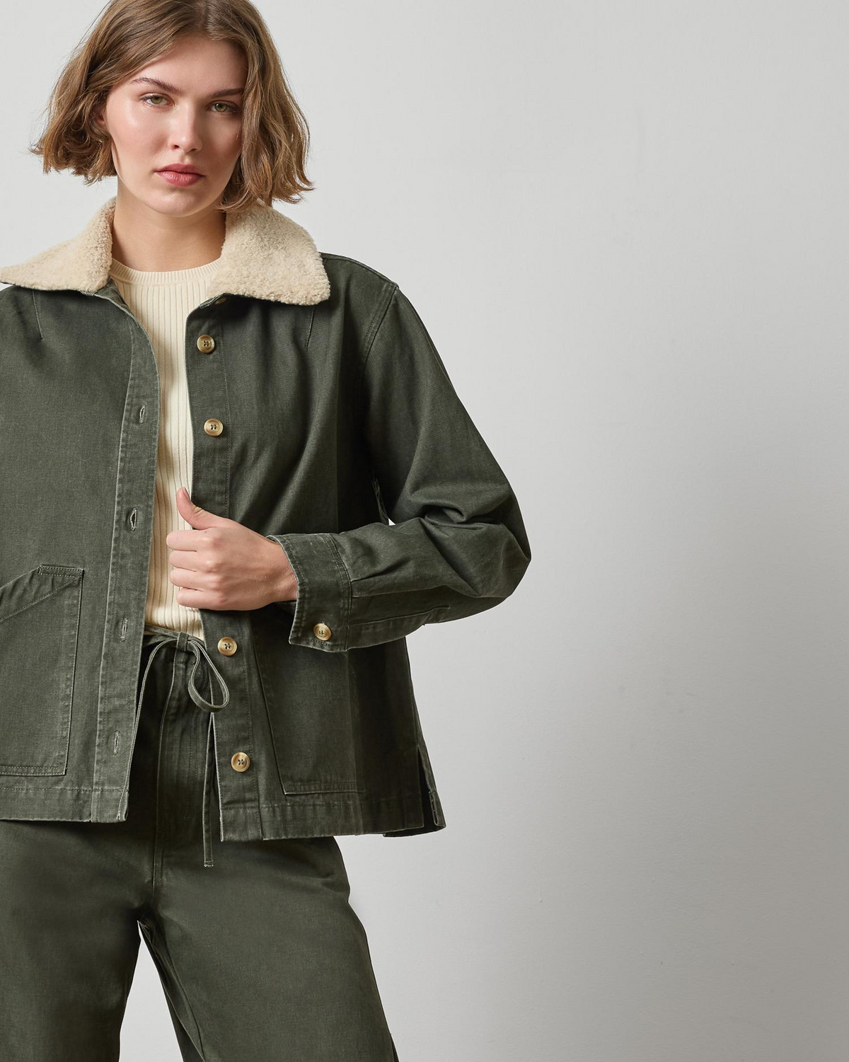 Washed olive green twill jacket with sherpa collar and gold buttons