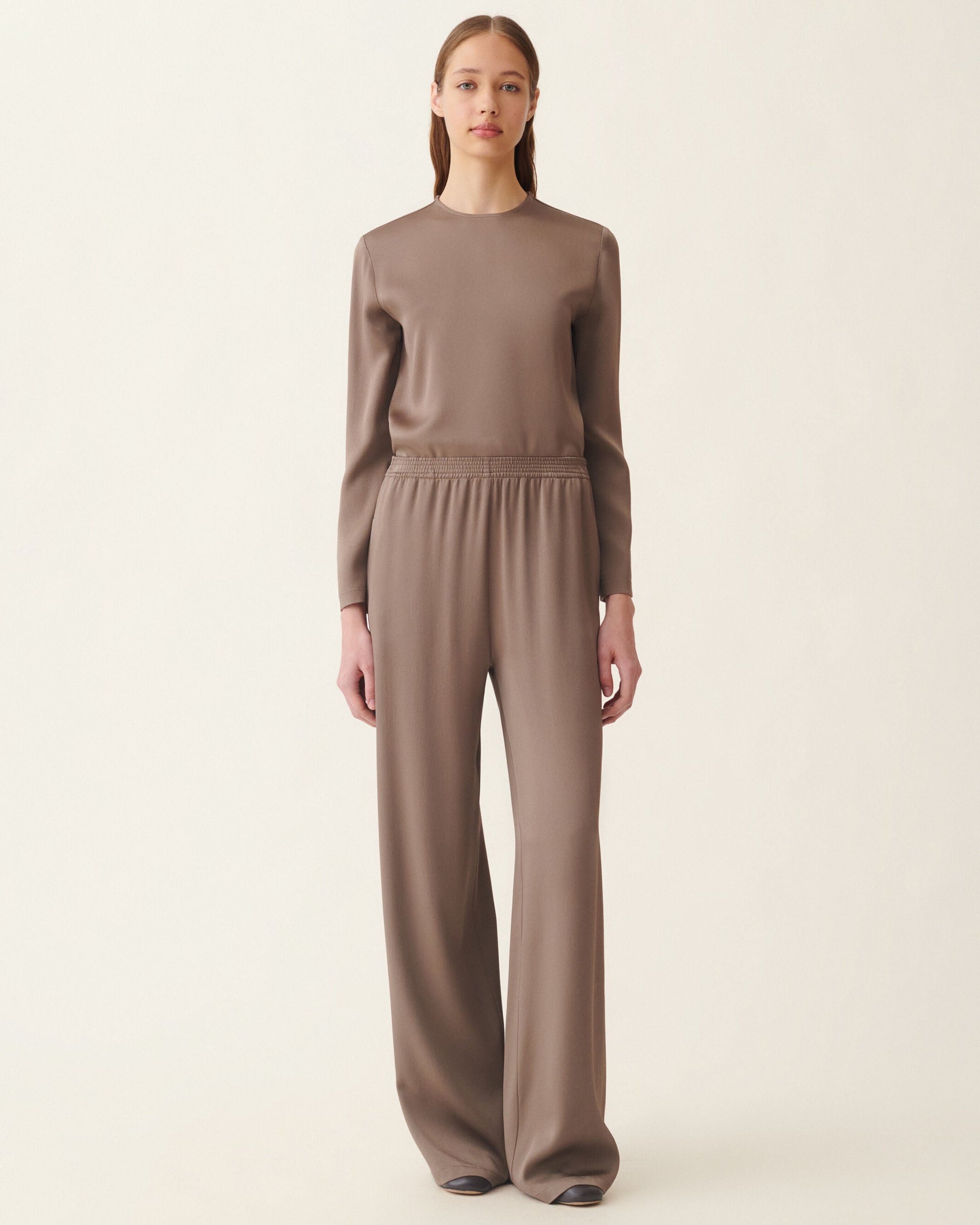 Wide-leg falcon brown satin trousers with smocked elastic waistband, worn with matching top