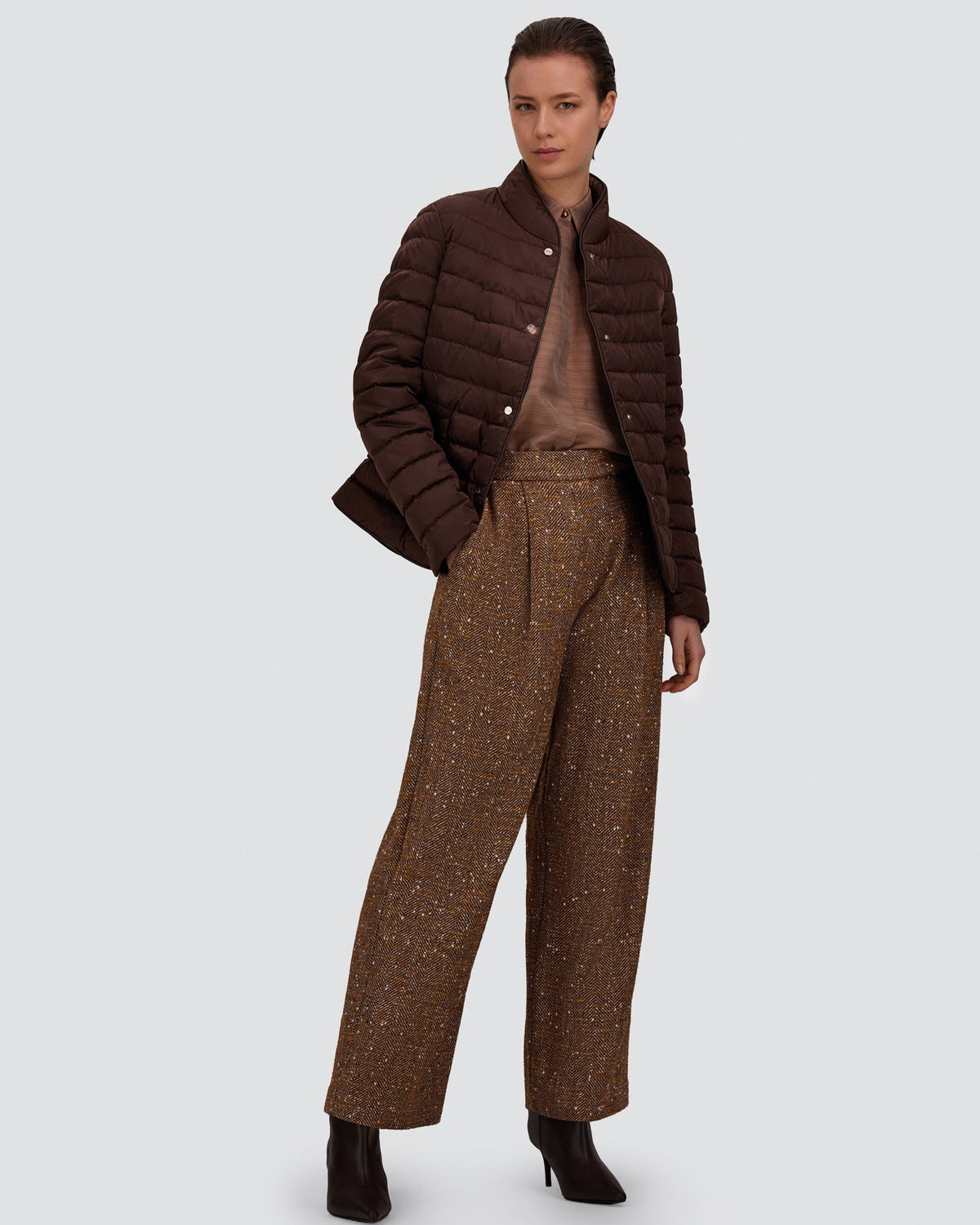 Herno chocolate brown quilted blazer with snap buttons, worn open over tweed trousers