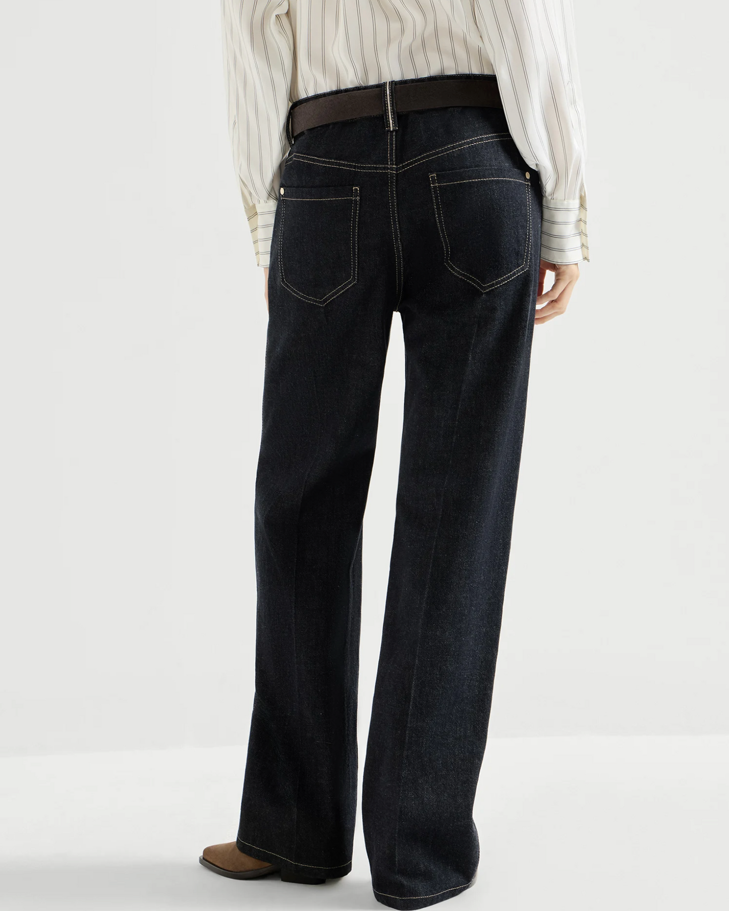 Dark denim wide-leg trousers with contrast stitching, back pockets, and brown belt