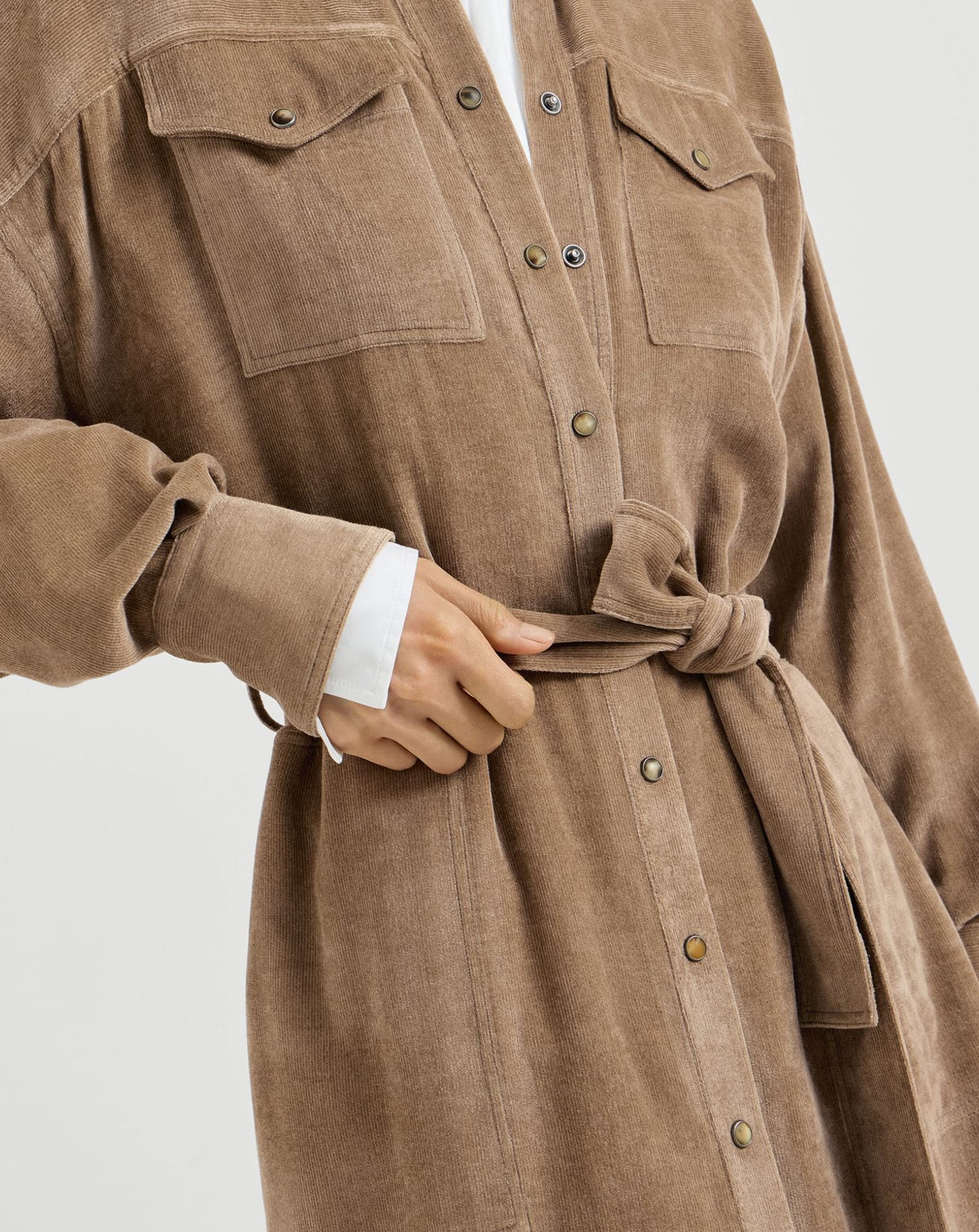 Cappuccino corduroy shirt dress with snap buttons, chest pockets, and tie waist belt