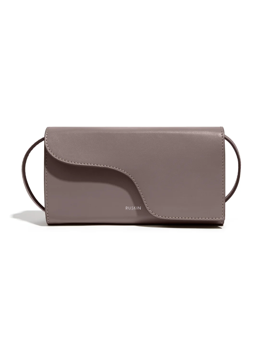 Ruskin England Petite Camille crossbody bag in taupe leather with curved flap closure