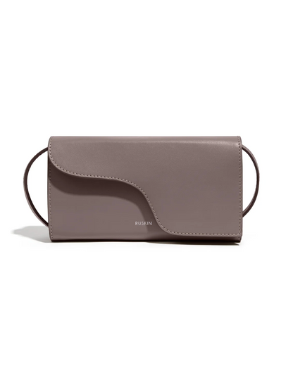 Ruskin England Petite Camille crossbody bag in taupe leather with curved flap closure