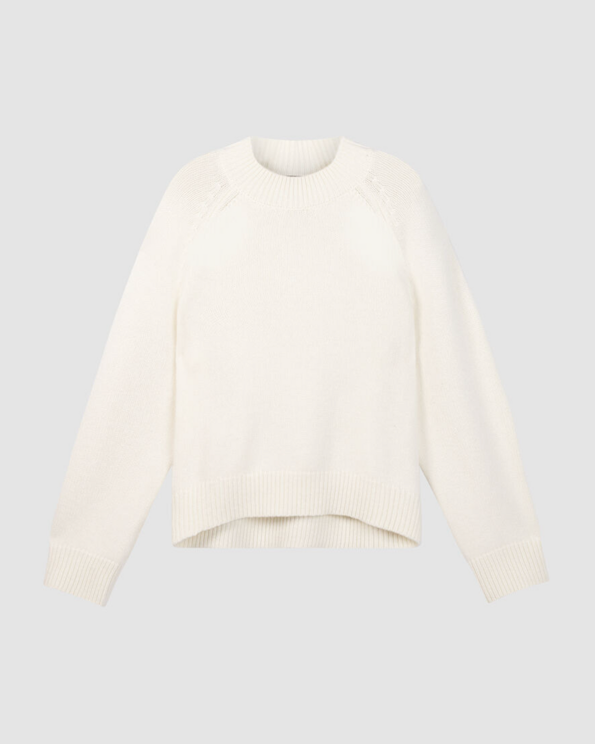 Cream chunky knit crewneck sweater with raglan shoulders and asymmetrical hem