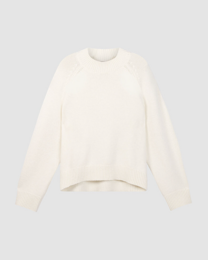 Cream chunky knit crewneck sweater with raglan shoulders and asymmetrical hem