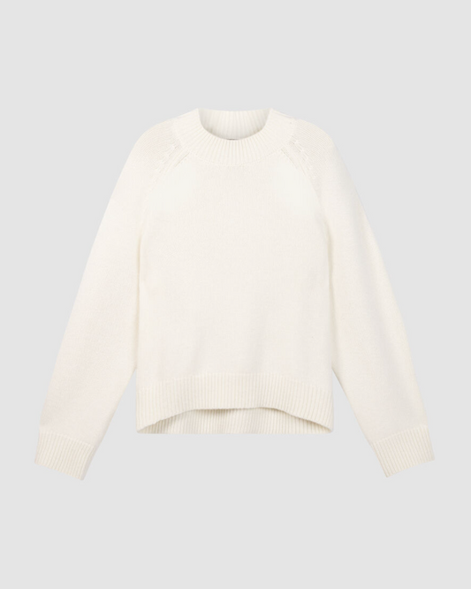 Cream chunky knit crewneck sweater with raglan shoulders and asymmetrical hem