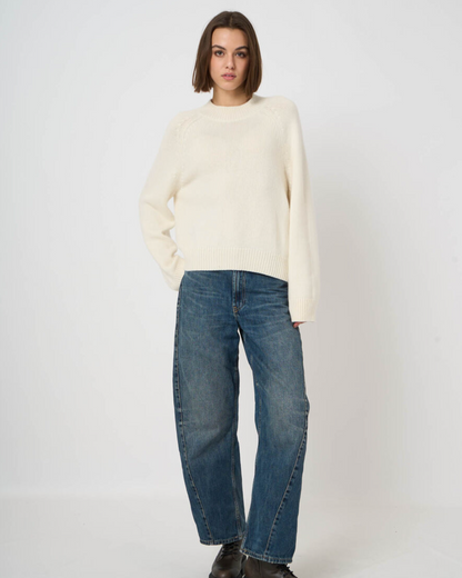 Cream chunky knit crewneck sweater with ribbed cuffs and hem, styled with wide-leg jeans