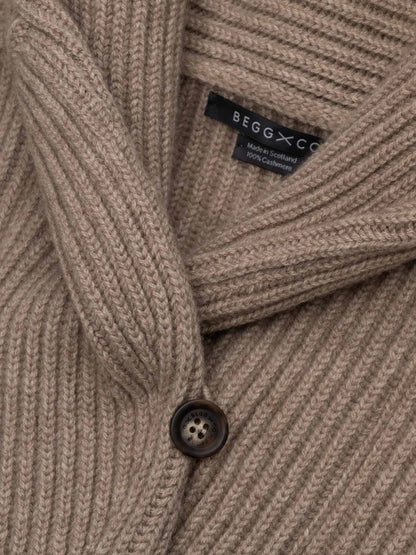 Close-up detail of Begg x Co 100% cashmere ribbed cardigan with shawl collar and branded button