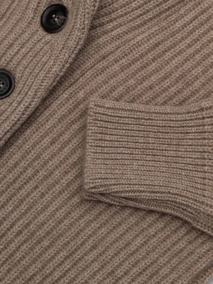 Close-up detail of ribbed brown undyed knit cardigan showing cuff and button placket